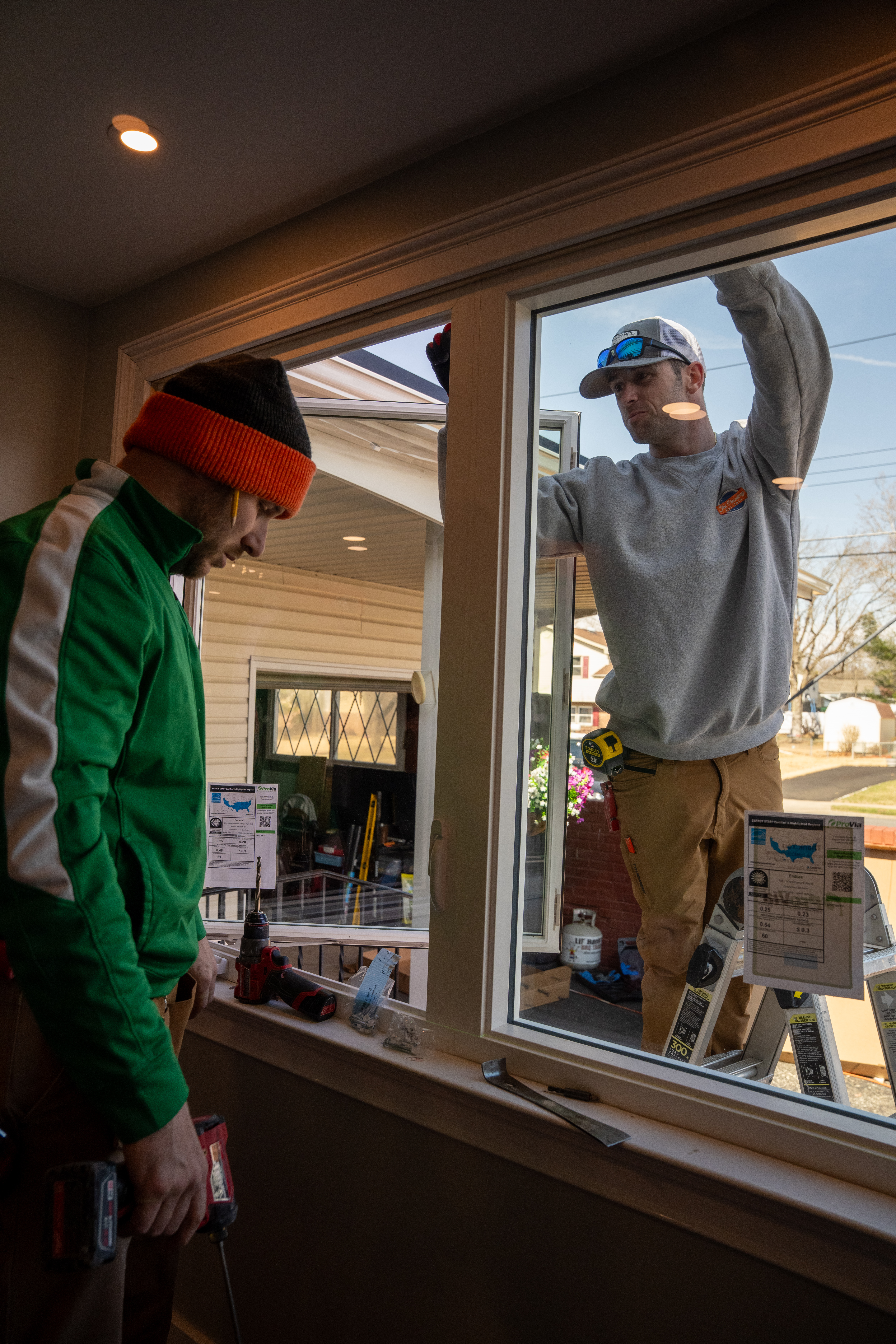 Window installation team fitting new window units at Cinnaminson project