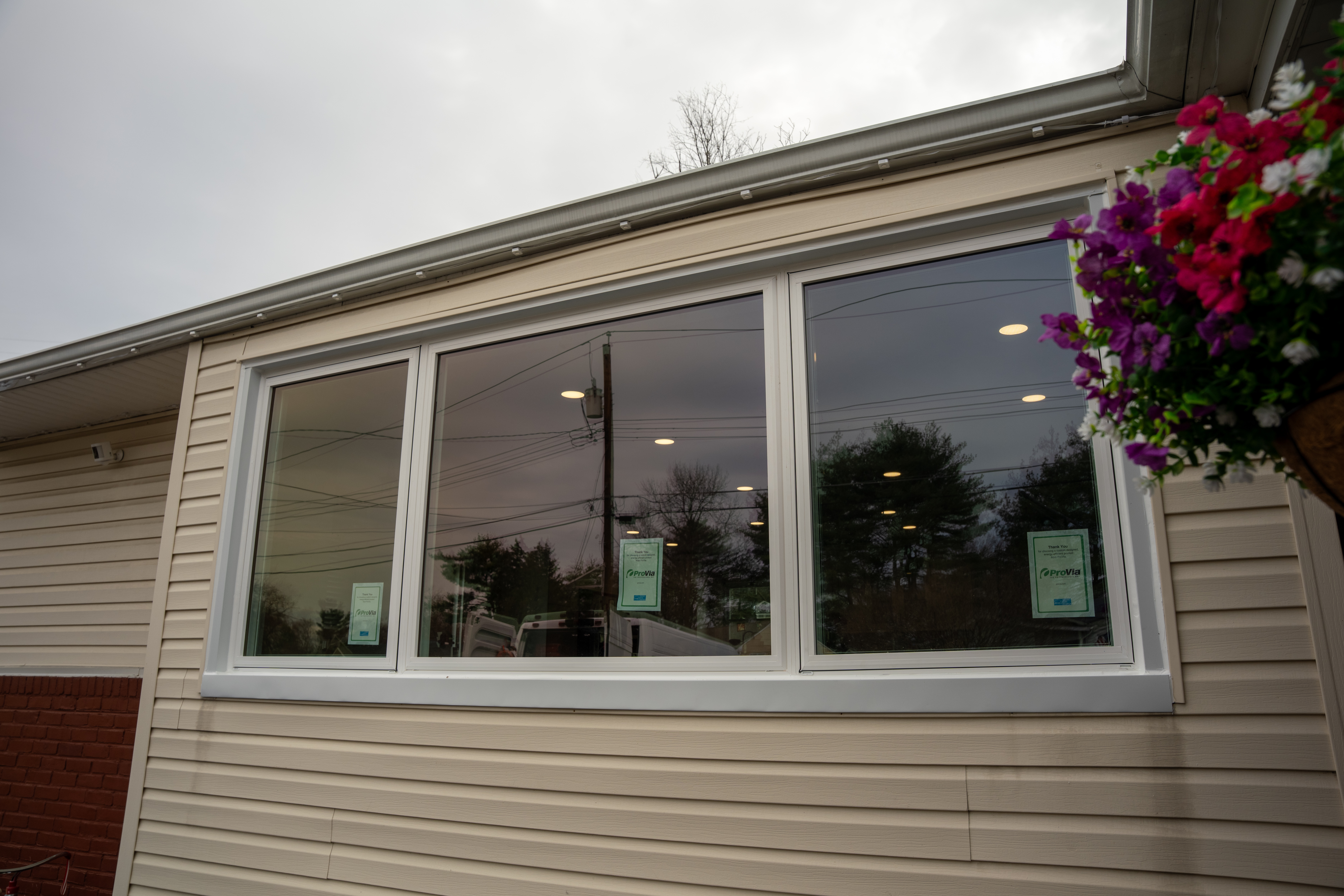 Large white replacement windows installed on Cinnaminson home exterior